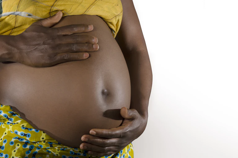A pregnant woman holding her belly