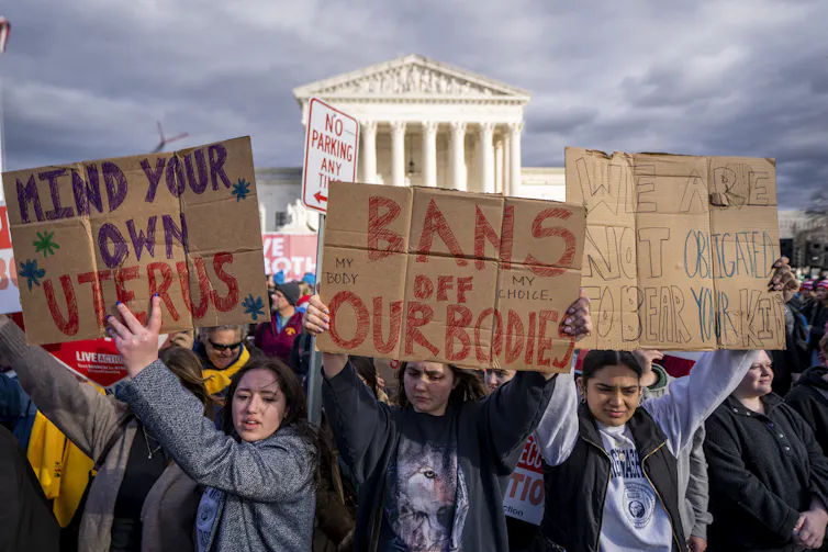 Women holding pro-choice banners outside of the Supreme Court
