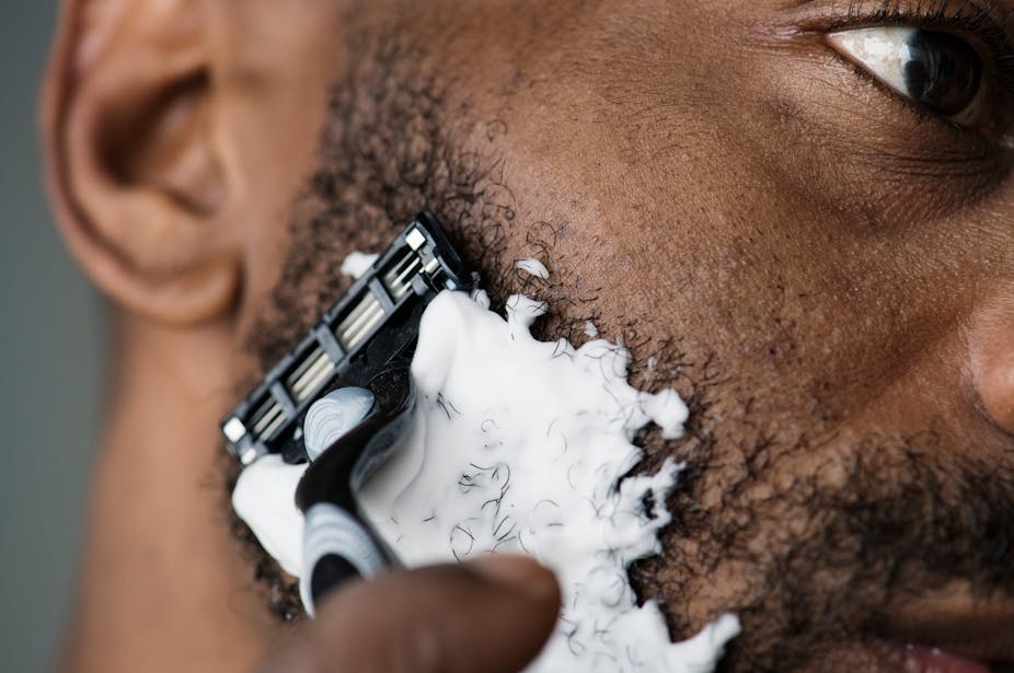 A man shaving his beard