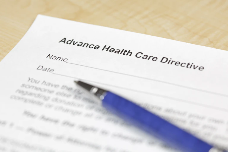 A piece of paper titled "Advance Health Care Directive" and a pen