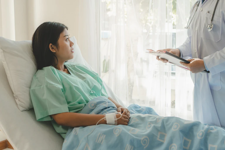 Hospital patient looks at her doctor