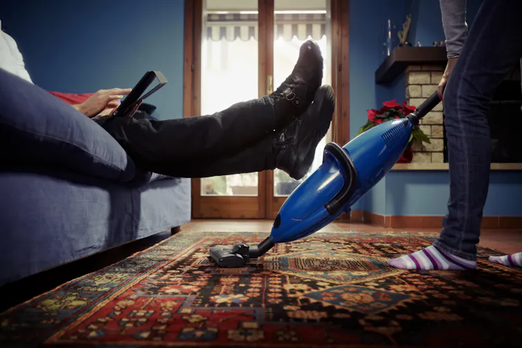 Woman vaccuming at home