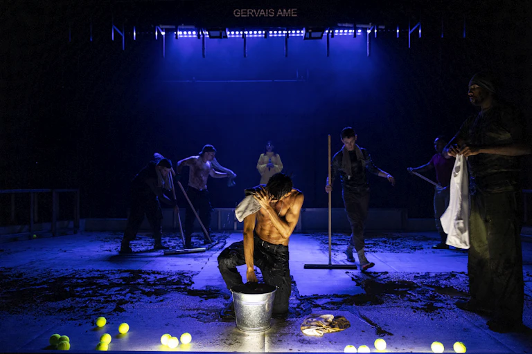 Production image: a man washes in a bucket.