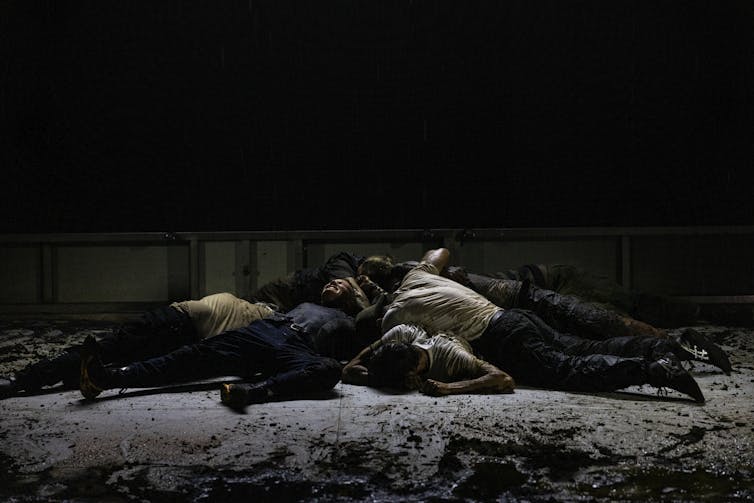 A pile of bodies on stage.
