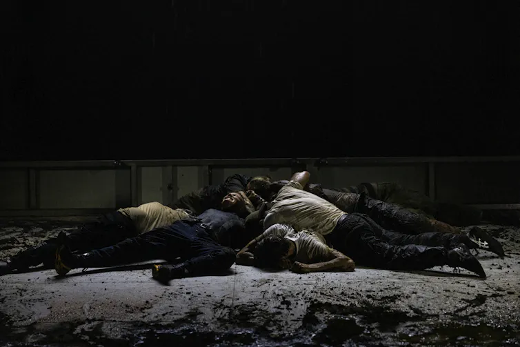 A pile of bodies on stage.
