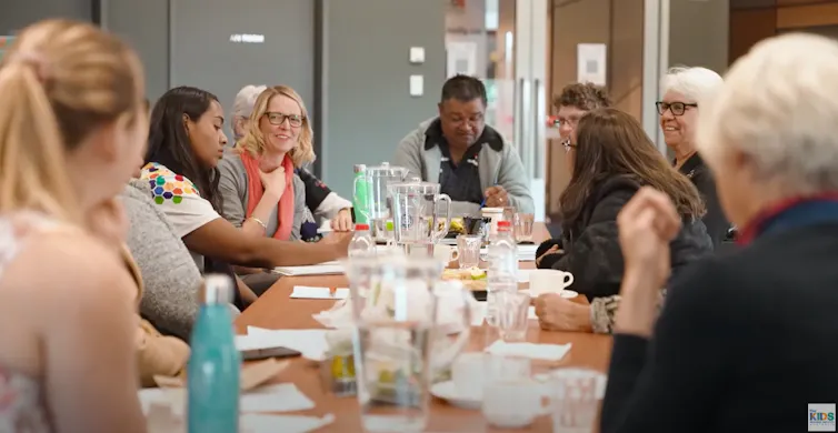 People sitting around a table talking animatedly.