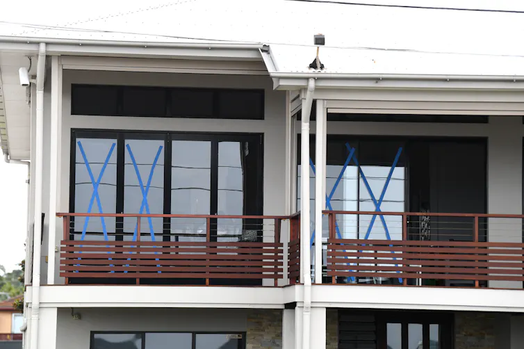 Windows are taped at a house in Sandgate in Brisbane, Queensland, Thursday, March 6, 2025, ahead of Cyclone Alfred