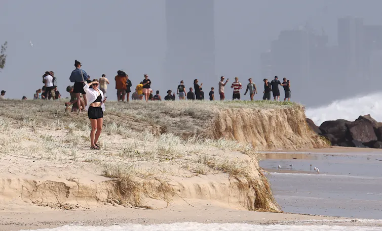 people look out to sea from beach