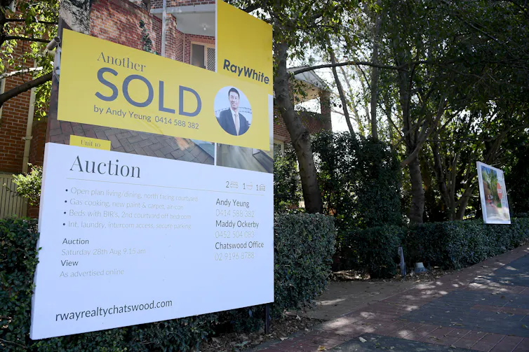 Auction sold sign outside house