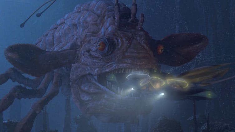 Movie still showing a submersible chased by an enormous anglerfish-like monster.