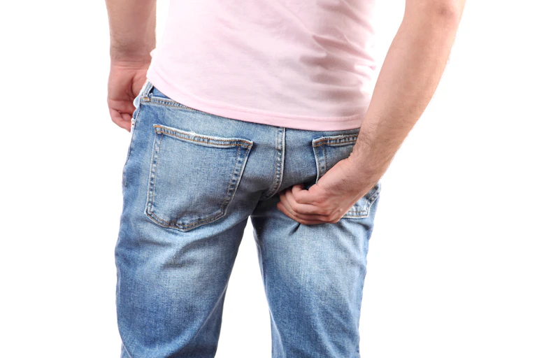 Man scratching his bum.