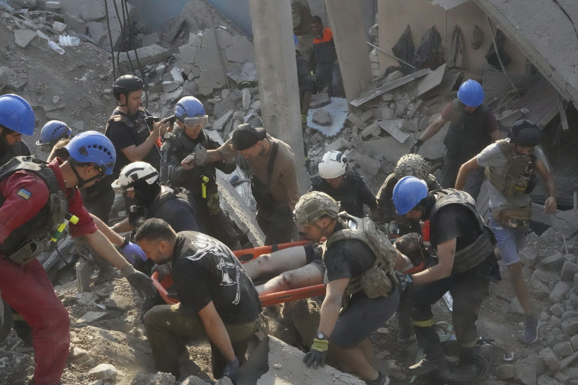 Emergency workers carry a man out of rubble.