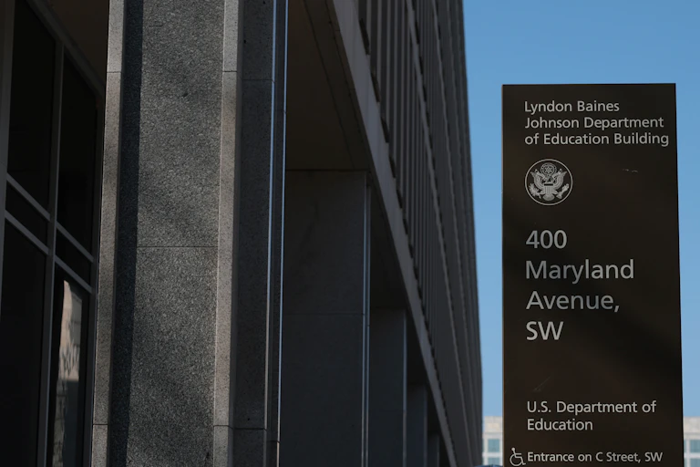 An Education Department sign appears in front of a building.