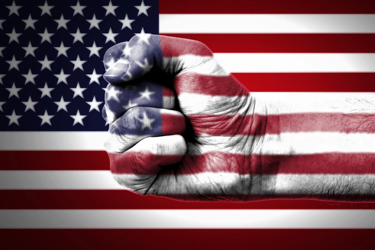 A fist punches through a large American flag in a graphic.