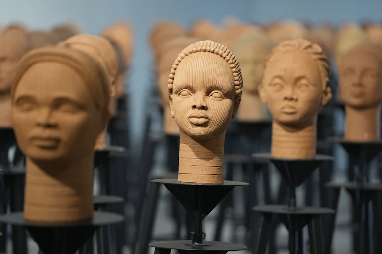 A series of sculptures on stands depicting some of the kidnapped Nigerian girls