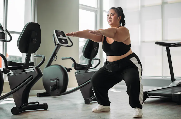 Woman in gym doing squats