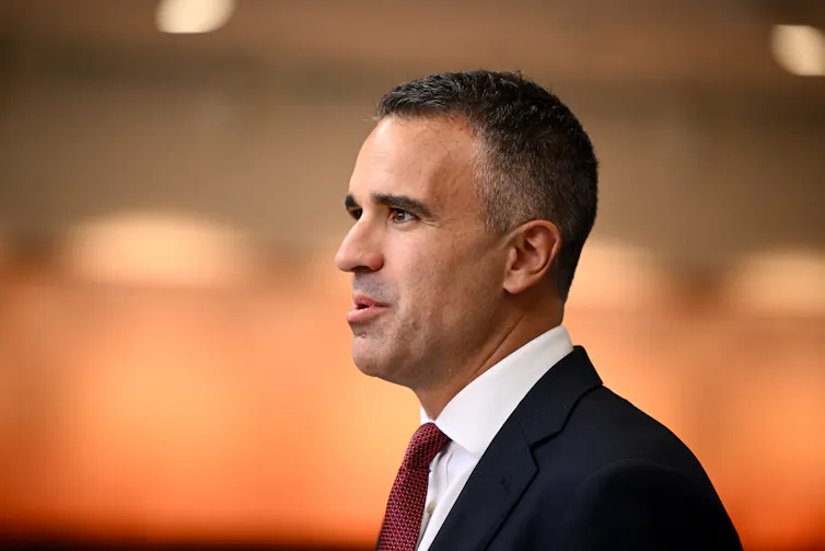 A man's side profile in a suit