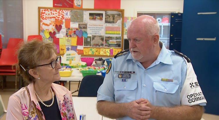 SES officials talk to a woman