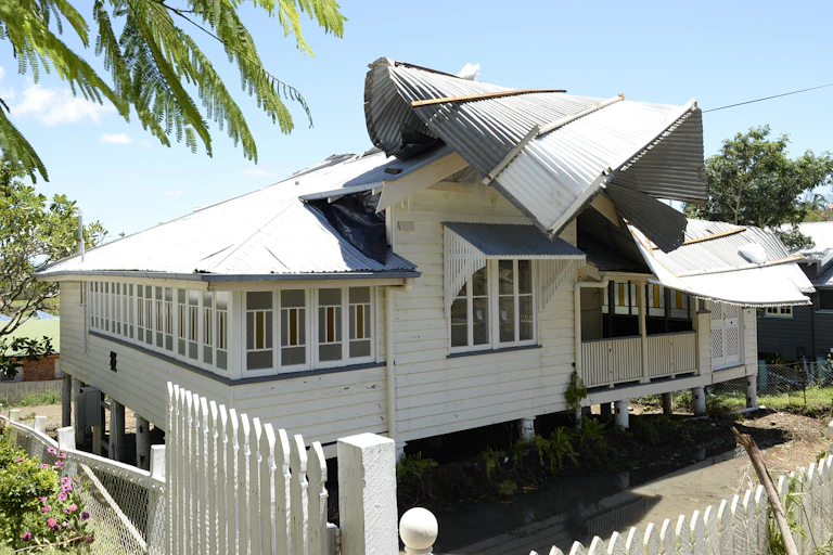 A house sits with its roof ripped off after a cyclone
