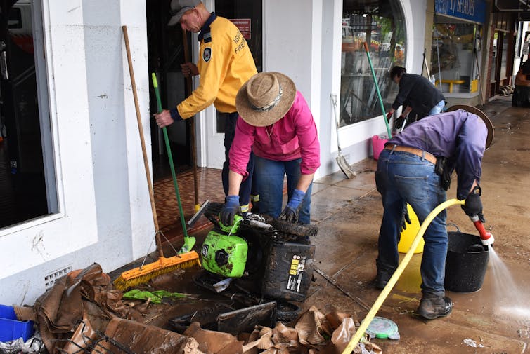 Volunteers and business owners remove debris from the central business district and clean up stock after flooding in the town of Molong, in the Central West region of New South Wales, Monday, November 14, 2022.