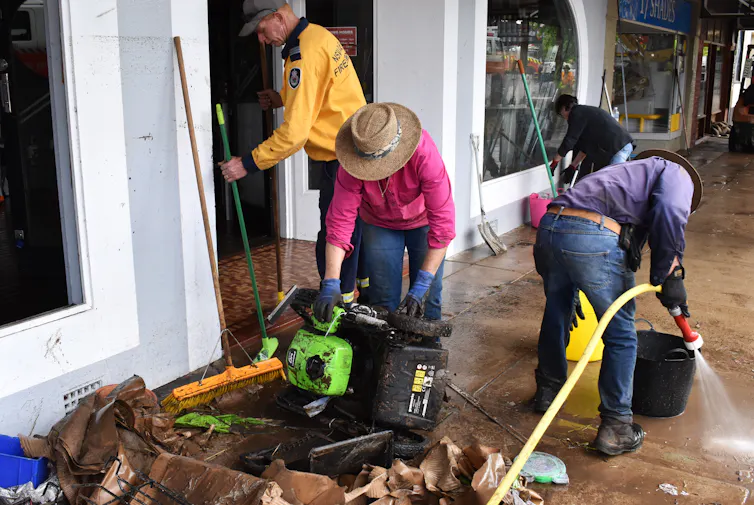 Volunteers and business owners remove debris from the central business district and clean up stock after flooding in the town of Molong, in the Central West region of New South Wales, Monday, November 14, 2022.