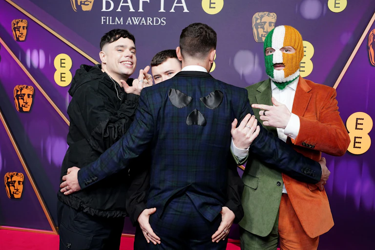 Four young men celebrating on the Bafta podium.
