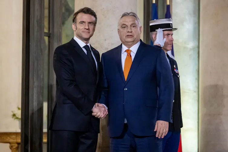 Emmanuel Macron shaking hands with Viktor Orbán