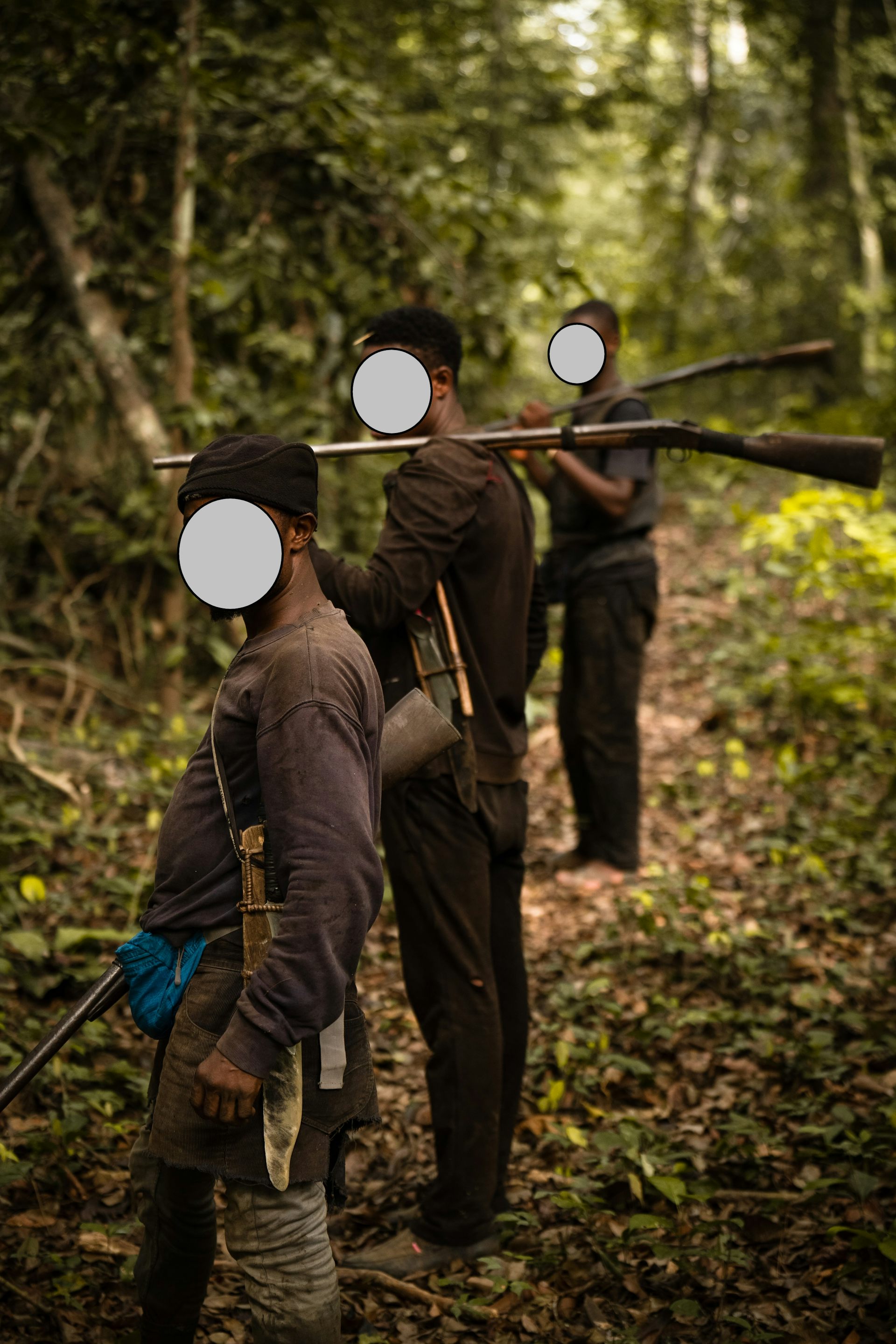 Three hunters, faces blurred out