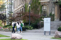 Students walk in front of a university building