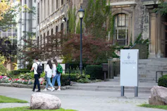 Students walk in front of a university building