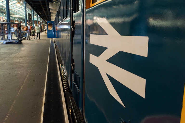 blue railway carriage with british rail logo painted on the side