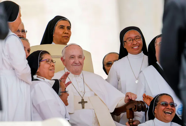 Pope Francis surrounded by nuns.