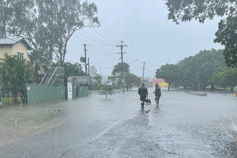 People battle rain in the wake of Alfred.