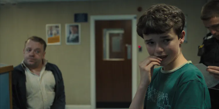 A young man biting his nails