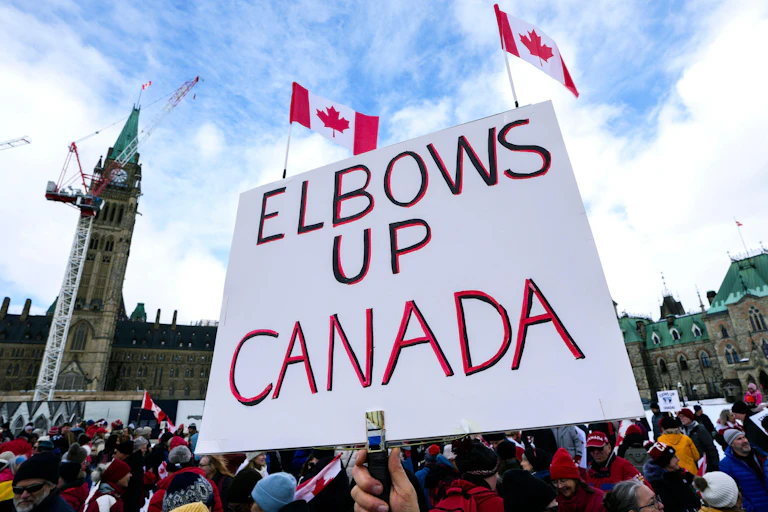 A protest sign saying: Elbows up Canada.