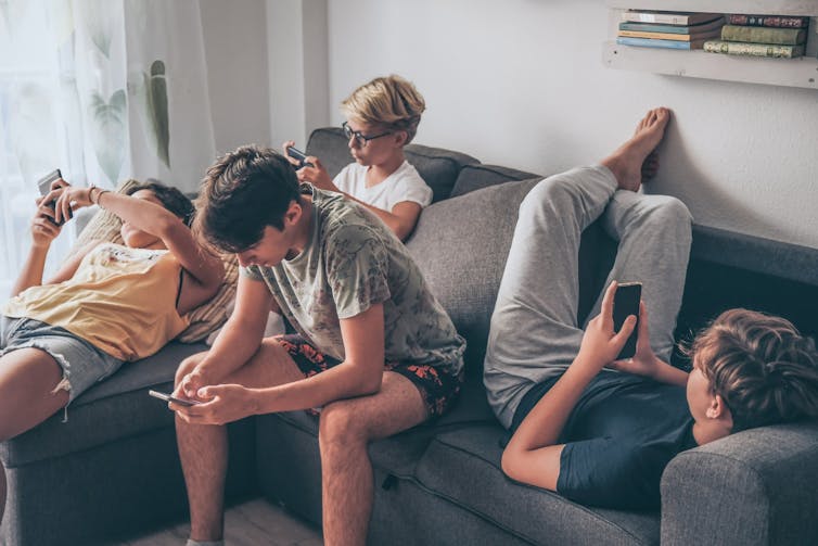 Group of teenagers on their phones