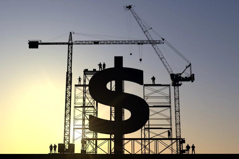 Huge dollar sign being constructed by cranes