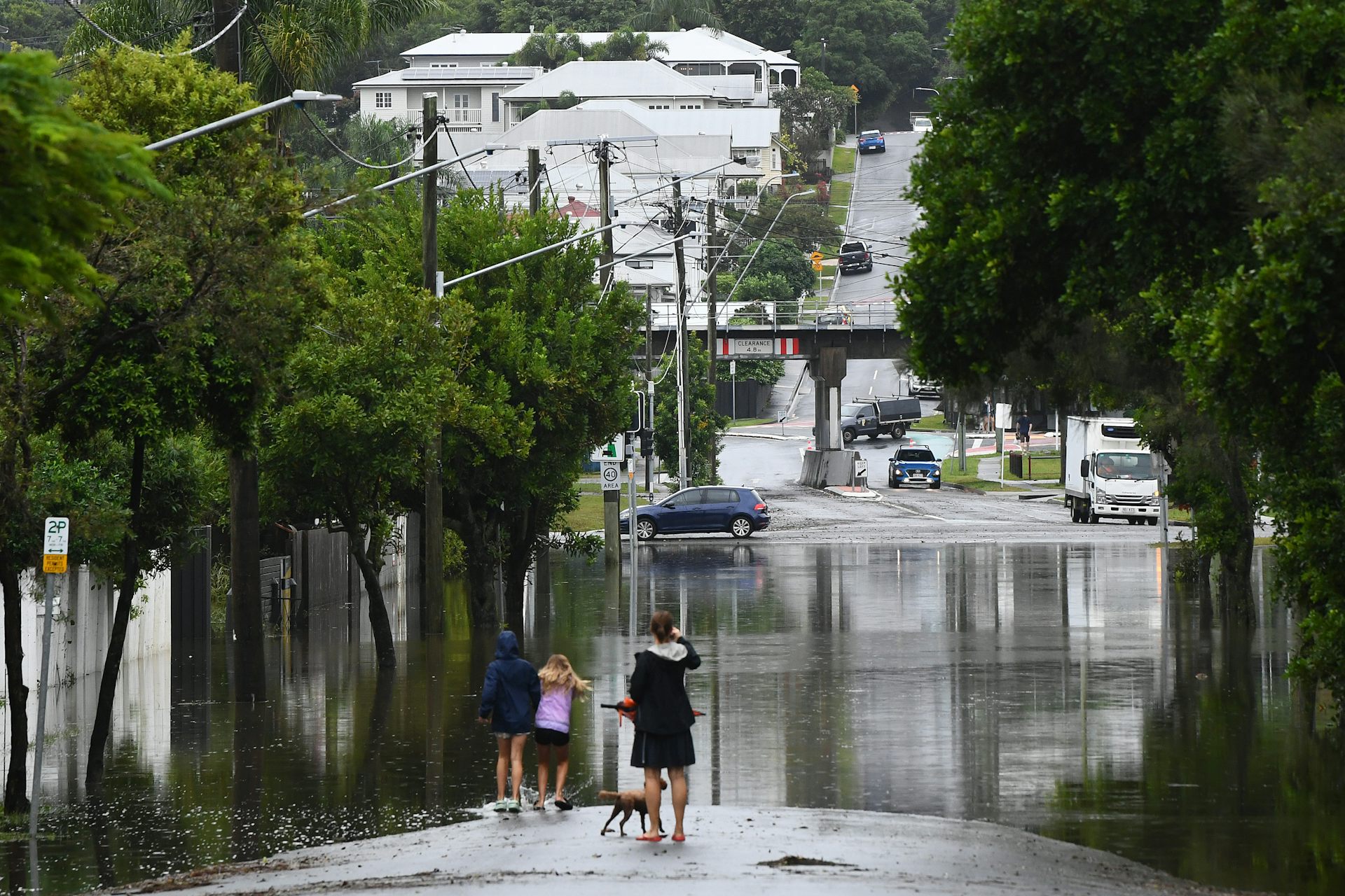 Residents look at flooding on their street in Newmarket, in Brisbane.