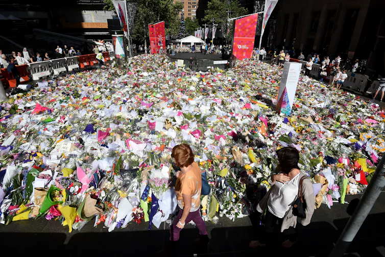 A big blanket of bunches of flowers cover a city street