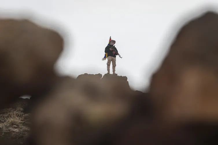 A Druze fighter on a hilltop.