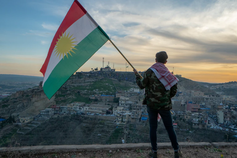 A man waves the Kurdistan flag in northern Iraq.