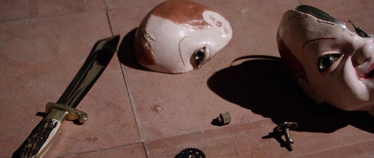 Reviewing 'Giallo': 50 years of premiere 'darkish crimson' 1 The doll's head broken on the ground next to the knife.