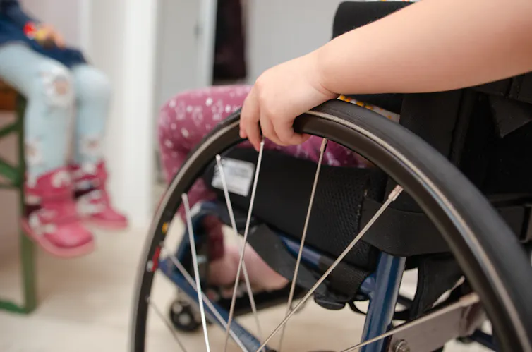 A child in a wheelchair.