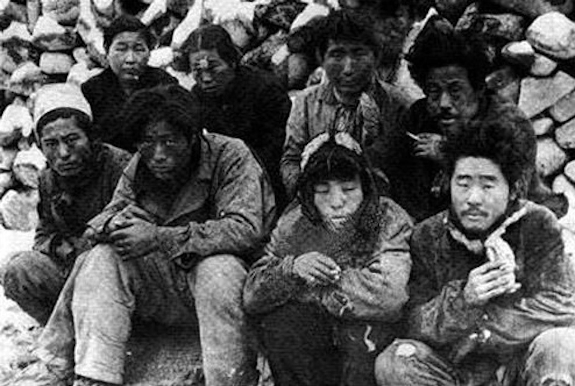 A group of incarcerated Korean people from Jeju island looking cold and miserable, awaiting execution.