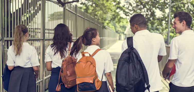 Teenagers in uniform walking to school