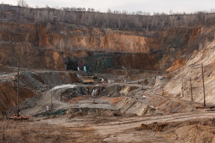 Machinery work in a deep open mine.
