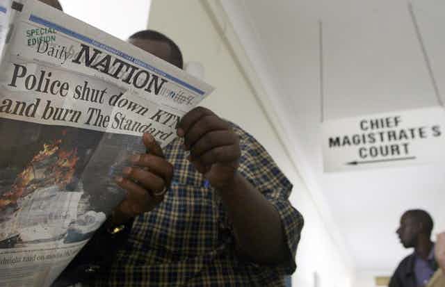 A man holding a newspaper