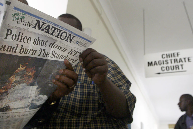 A man holding a newspaper