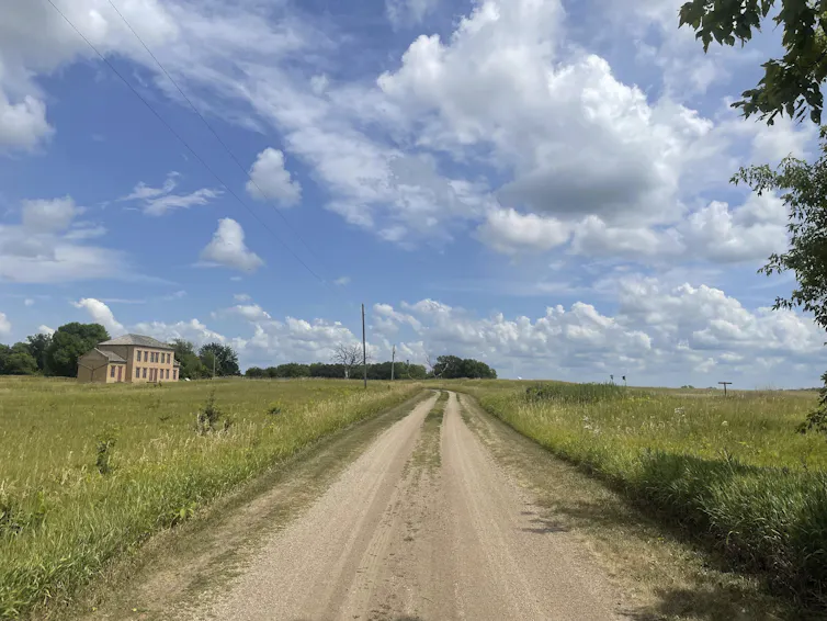 A road runs through prairie land