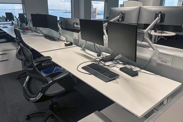 Empty desks are in an office building.